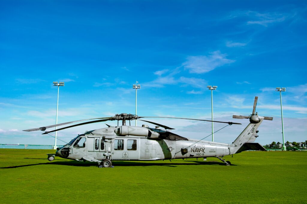 Navy helicopter sitting on a grass field
