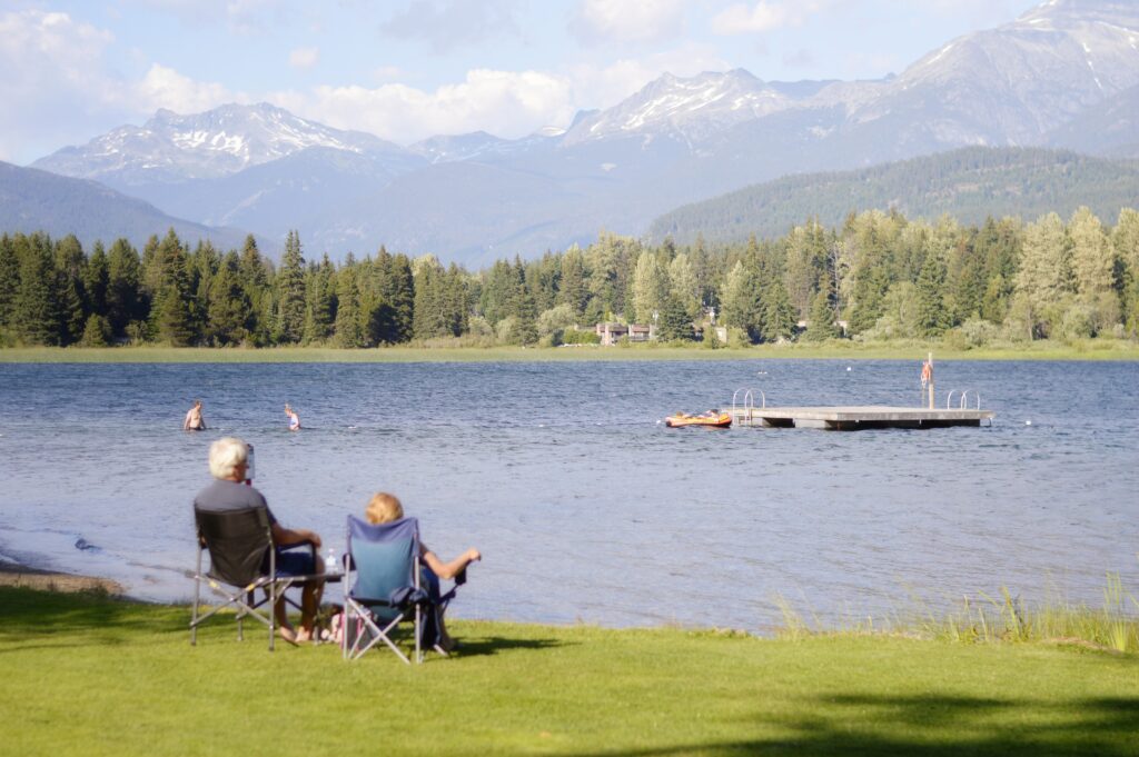 old couple sitting in chairs by the water