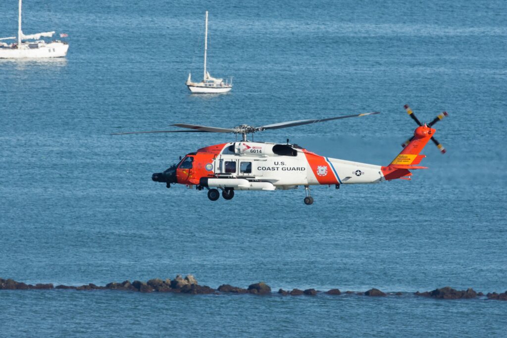 coast guard orange and white search and rescue helicopter