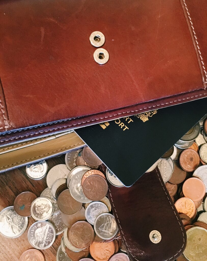 picture of a passport and coins under a folder